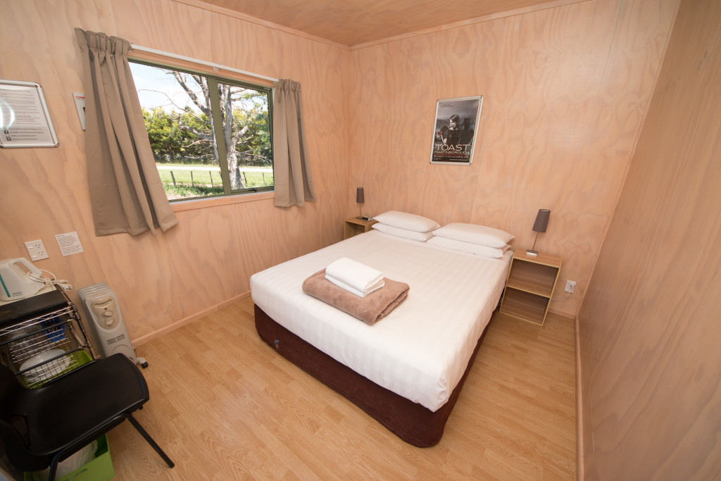 Small and comfortable cabins with Queen bed, sharing communal holiday park facilities.