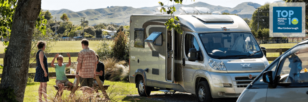 Guests talk outside their campervan at Martinborough TOP 10 Holiday Park